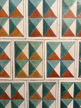 Geometric pattern on colorful tiled surface, ideal for backgrounds with vib.. Stock Photos