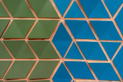 Geometric pattern composed of green and blue triangular tiles. Neatly arranged Stock Photos