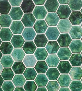 Geometric pattern of green wall tiles adds depth and style to indoor spaces Stock Photos