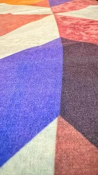 Geometric pattern on multicolored textured fabric Stock Photos