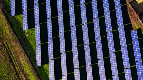 Geometric pattern of parallel solar panel rows on grass, Bulgaria Stock Footage 336341656