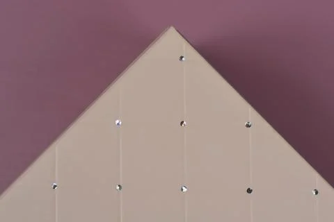 Geometric pattern on pyramid shaped object over purple background Stock Photos