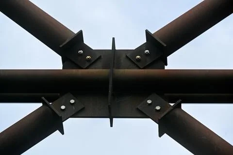 Geometric pattern of round iron struts against blue sky for use as backgrou.. Stock Photos