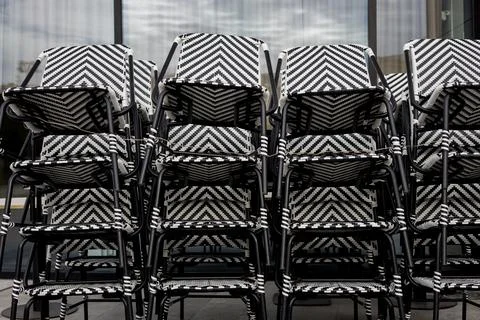 Geometric pattern of stacked black and white bistro chairs. 写真素材