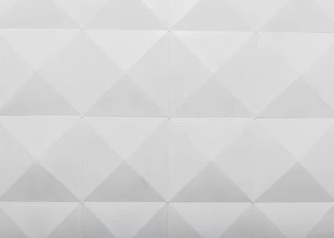 Geometric pattern of white triangular shapes on a textured surface in a Stock Photos
