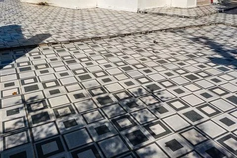 Geometric patterned outdoor tile floor with square design in black and whit.. Stock Photos