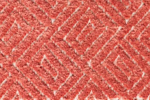 Geometric patterned red carpet texture background close up Stock Photos