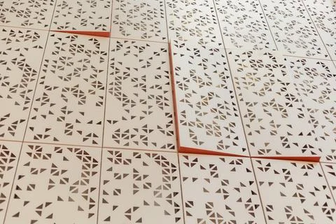 Geometric patterns are laid out on a flat surface in a workspace. The shapes  Stockfoto's
