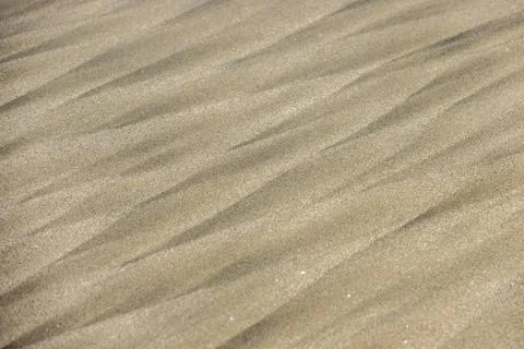 Geometric patterns in the sand left by passing waves Stock Photos