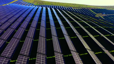 Geometric patterns of solar panel rows on rolling hills Video stock 334318233
