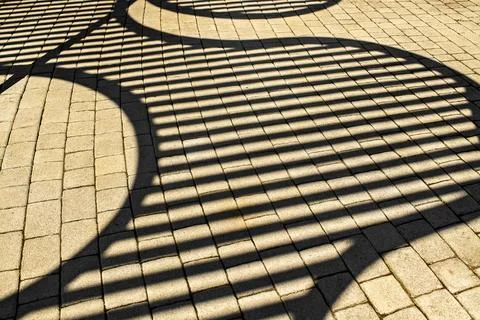 Geometric Pergola Shadow Pattern On Paving Stone Footpath Stock Photos
