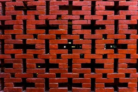 Geometric Red Brick Screen Wall with Intricate Repeating Pattern Stock Photos