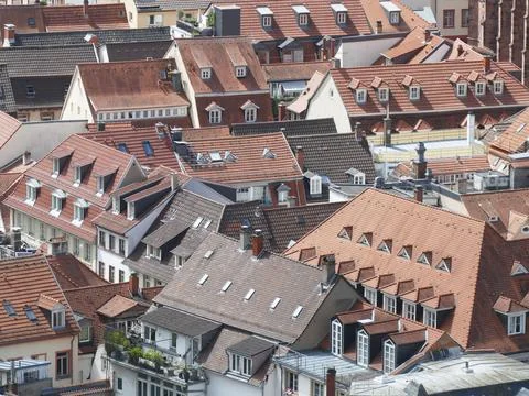 Geometric red tile rooftops overlapping historic Nuremberg cityscape Foto stock