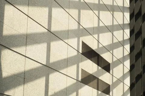 Geometric shadows create abstract pattern on modern facade Stock Photos
