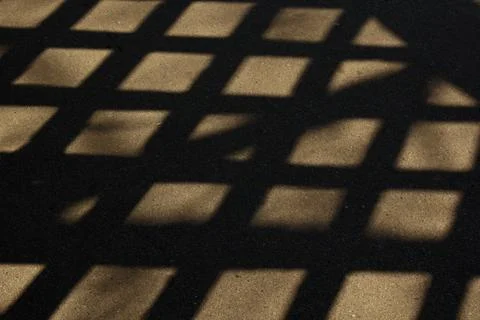 Geometric shadows from the grid on the ground. view from above. background, t Stock Photos