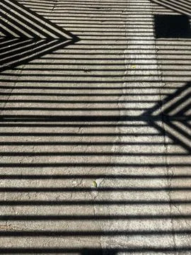 Geometric shadows on the pavement Stock Photos