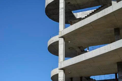 Geometric shape made of concrete on a background of blue sky. Stock Photos