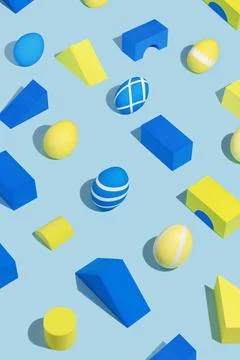 Geometric shapes and decorated Easter eggs with hard shadows on a light blue Stock-Fotos