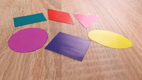 Geometric shapes cut out of colored paper, learning geometry, shapes Stock Footage 317326508