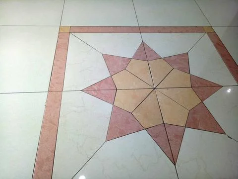 Geometric star mosaic pattern in marble floor tiles with pink border, symme.. Stock Photos