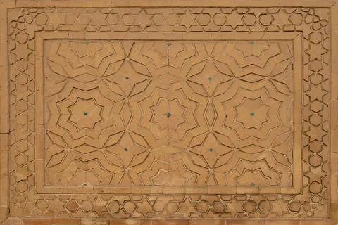 Geometric star pattern ganch carved in terracotta brickwork on a historic I.. Stock Photos