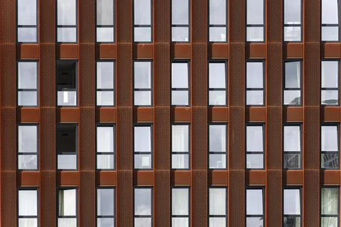 Geometric symmetrical pattern of a Modern copper colored building facade Stock Photos