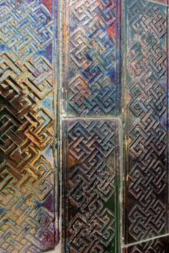 Geometric tiled surface showing a metallic texture with an iridescent oil s.. Stock Photos