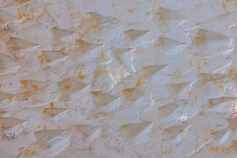 Geometric triangle pattern on stucco surface Stock Photos
