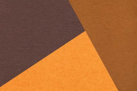 Geometric triangular dark brown orange rust textured paper background with .. Stock Photos