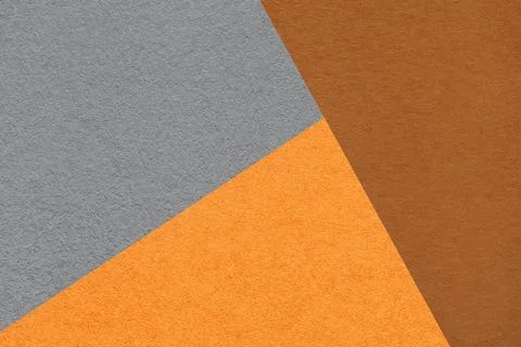 Geometric triangular gray orange brown textured paper background with copy .. Foto stock