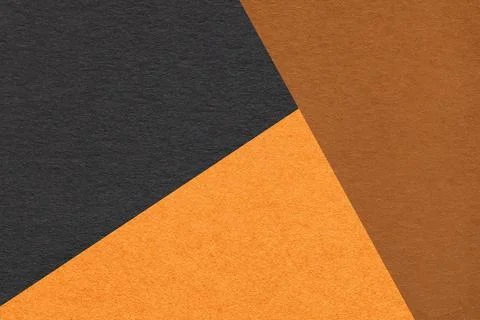 Geometric triangular orange brown black textured paper background with copy.. Illustrazione stock