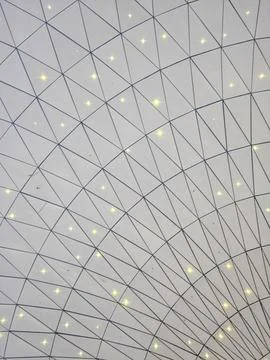 Geometric white ceiling grid with triangles and star-like lights Stock Photos