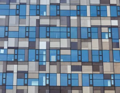 Geometric Window Pattern on Modern Building Facade Stock Photos