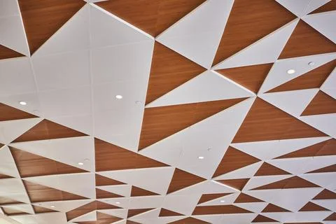 Geometric Wooden Ceiling with Triangular Panels Eye-Level View Stockfoto's