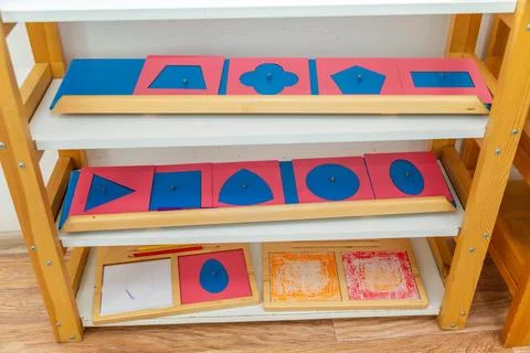 Geometrical figures learning materials on a shelf in a classroom Stock Photos