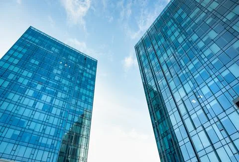 The geometry of modern urban architecture is reflected in the glass facades of Stock Photos