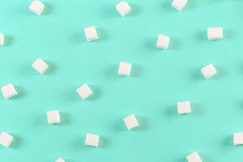 Geometry Pattern made of white sugar cubes on light blue background. Abstract Stock Photos