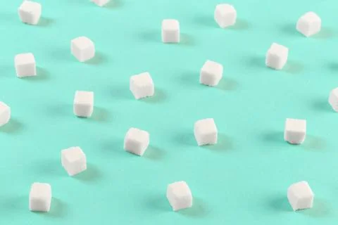 Geometry Pattern made of white sugar cubes on light blue background. Abstract Stock Photos