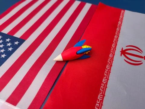 Geopolitical concept using a toy rocket situated between the flags of the U.. Stock Photos