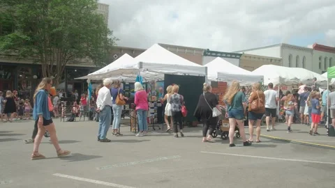 Georgetown TX crowds walking past festival vendor tents 4k Stock Footage 184751097