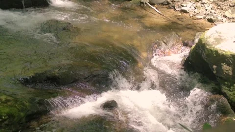 Georgia Anna Ruby Falls A close up of water flowing over several rocks on th Stock Footage 241693679