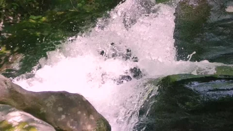 Georgia Anna Ruby Falls  A zoom out from a small waterfall with rocks on the Stock Footage 241693653