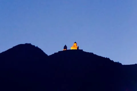Georgia, district Gergeti, Sameba Tsminda, monastery, illuminated in the evening Stock Photos