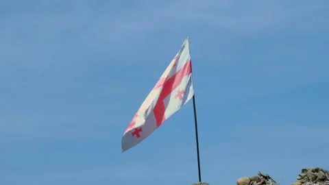 Georgia flag on blue sky background of top of the old tower Stock Footage 257353700