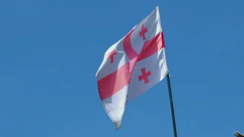 Georgia flag on blue sky background of top of the old tower Stock Footage 257353877