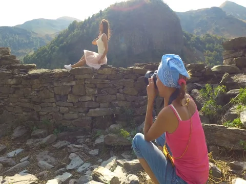 GEORGIA, SEPTEMBER 19, 2017: Two young women tourist photographer and model s Stock-Footage 83332333