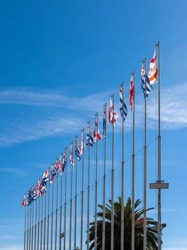 Georgian flags on flagpoles flutter in the wind against a blue sky Stock Photos