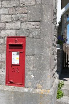 A Georgian postbox set into the side of a stone house in the Purbeck's area of Stock Photos