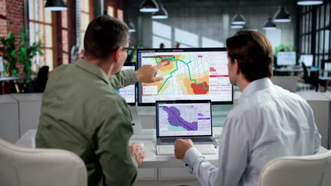 Geospatial Analyst And Colleague Study Flood Risk Map Stock Footage 346327457