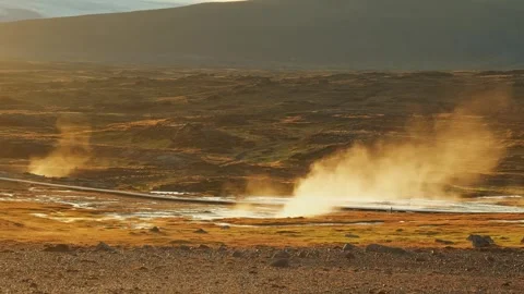Geothermal Hot Spring Landscape with Erupting Geyser and Wooden House at Sunset Stock Footage 320514895